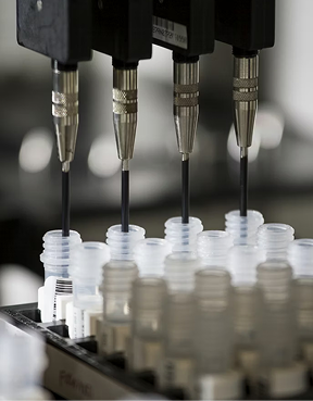 Automated laboratory pipettes filling research vials during peptide testing